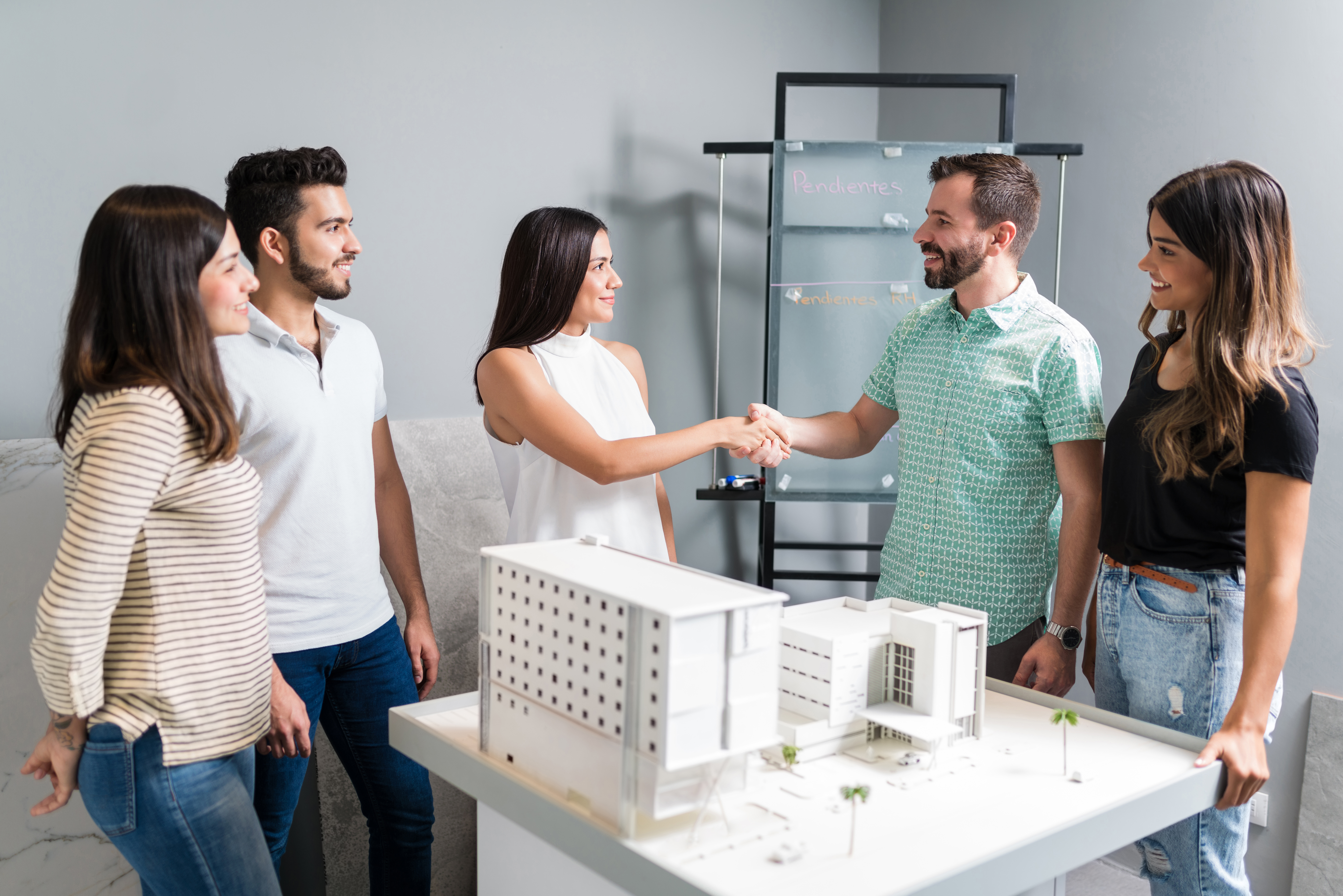 business-partners-shaking-hands-with-engineer-by-architectural-model-meeting.jpg